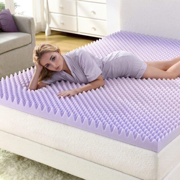 Woman laying on a foam mattress topper